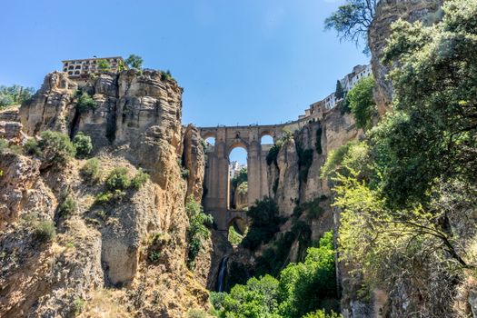 A gorge in the city of Ronda Spain, Europe on a hot summer day with clear blue skies