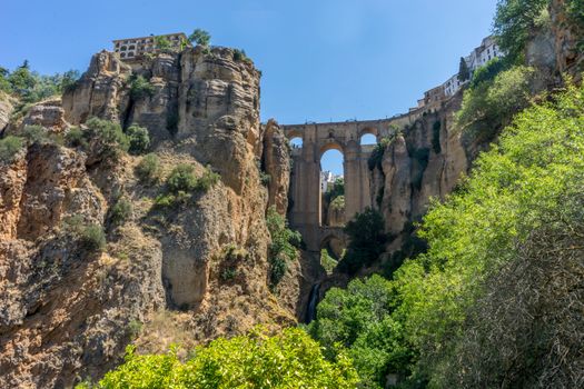 A gorge in the city of Ronda Spain, Europe on a hot summer day with clear blue skies