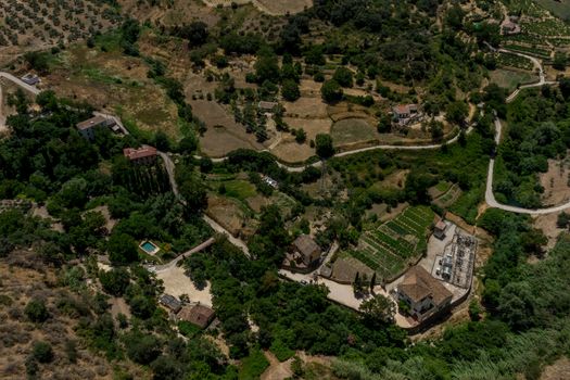 Greenery, Mountains, Farms and Fields on the outskirts of Ronda Spain, Europe on a hot summer day with clear blue skies