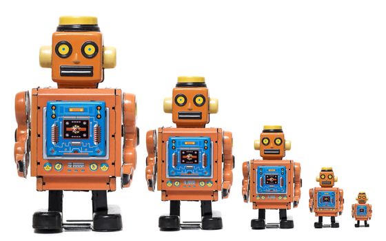 Vintage tin robot toy in different size scales isolated on a white background.