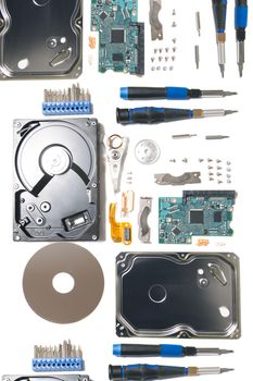 Disassembled hard disk drive parts isolated on a white background.