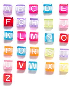 Colorful plastic beads alphabet isolated on a white background.