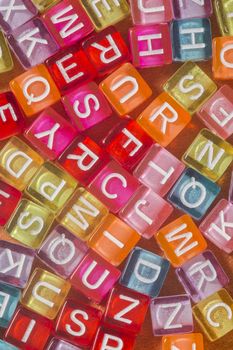 Colorful plastic beads with letters isolated on a white background.