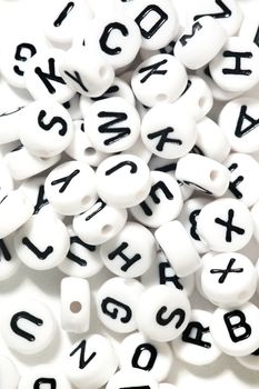 Plastic beads with letters isolated on a white background.