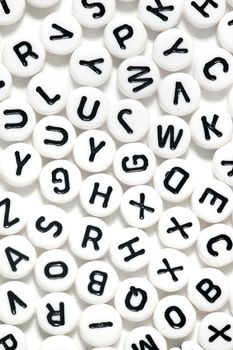 Plastic beads with letters isolated on a white background.