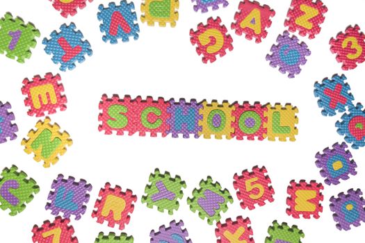 Foam puzzle letter uppercase with word School isolated on a white background.