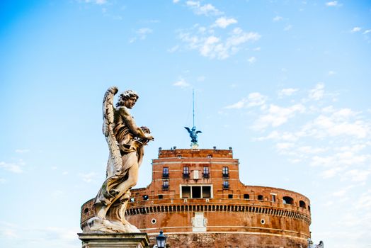 Italy, Rome, Castel Sant'Angelo, statue and castle with a large space of blue sky