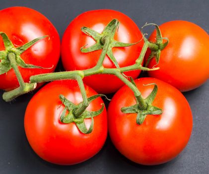 Freshly picked red tomatoes from the vine