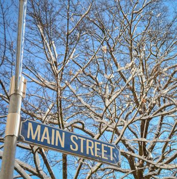 A Snowy Main Street Sign In Small Town America