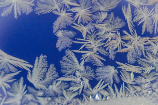 winter window close-up snow patterns on the Windows of frost, snow city