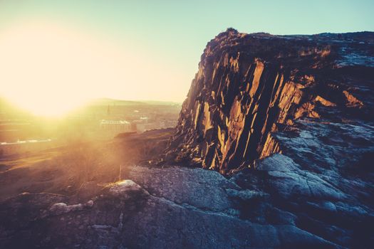 Low Winter Sun Over Edinburgh, Scotland, With Salisbury Crags In The Foreground