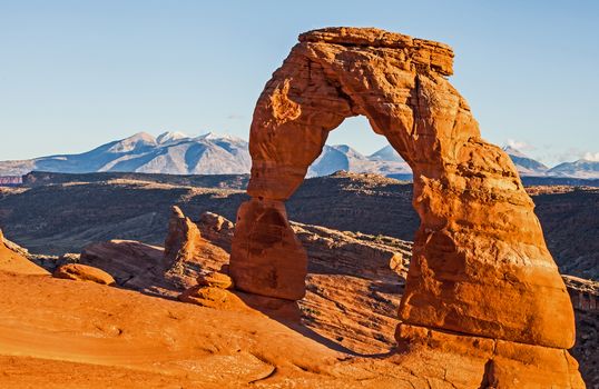 A late afternoon image of the Delicate Arch, with the Manti-Lasal mountains in the background.