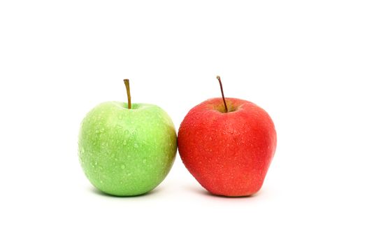 A pair of fresh washed apples, one green and one red, touching. Isolated on white background