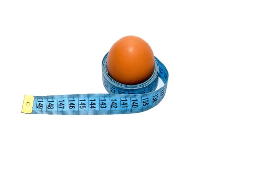 Egg wrapped in blue measuring tape, slimming concept.