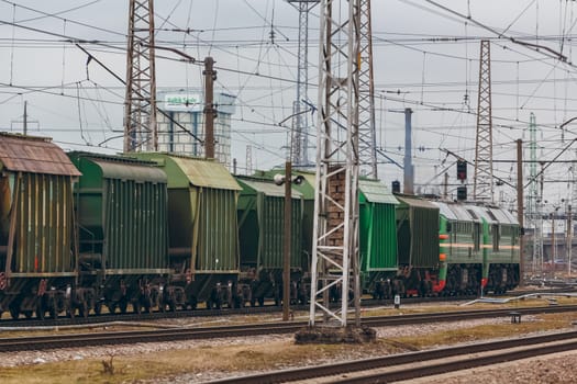 Green diesel cargo locomotive. Freight train in action