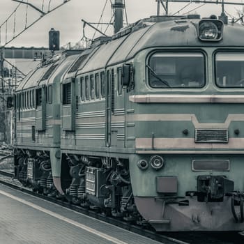 Old diesel cargo locomotive. Freight train in action