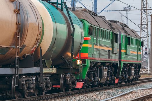 Green diesel cargo locomotive. Freight train in action