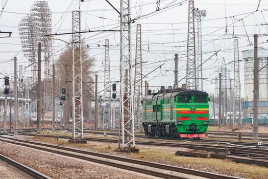 Green diesel cargo locomotive. Freight train in action