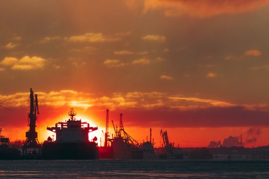 Colorful winter sunrise against the cargo port