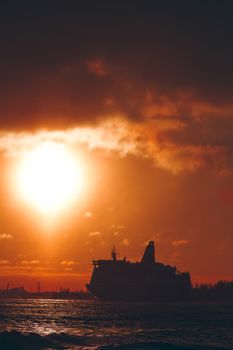 Hot orange winter sunrise against the cargo port