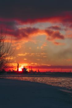 Colorful winter sunrise against the cargo port