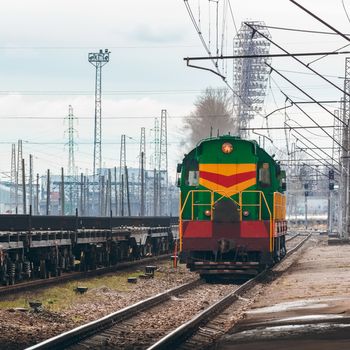 Green diesel cargo locomotive. Freight train in action