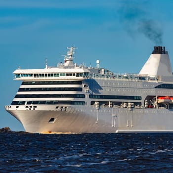 White cruise liner sailing on a clear day