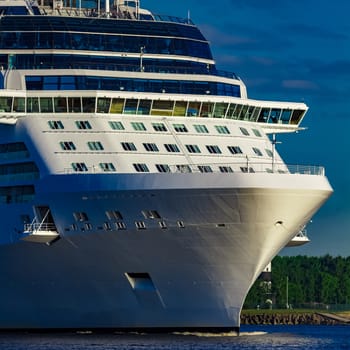 White giant brand new passenger ship moving in clear summer day