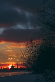 Colorful winter sunrise against the cargo port