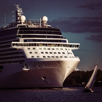 White giant brand new passenger ship moving in clear summer day