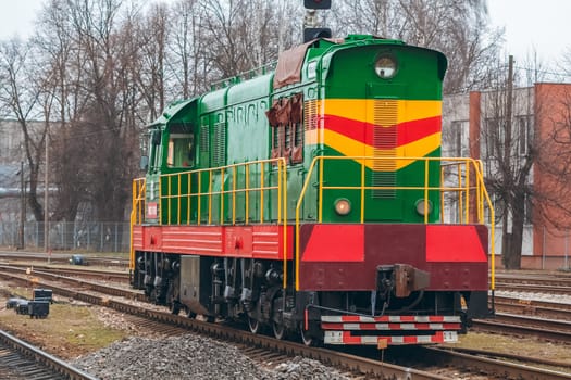 Green diesel cargo locomotive. Freight train in action