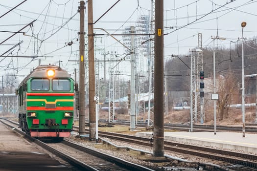 Green diesel cargo locomotive. Freight train in action