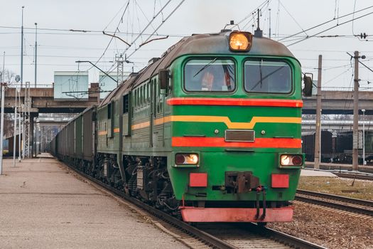 Green diesel cargo locomotive. Freight train in action