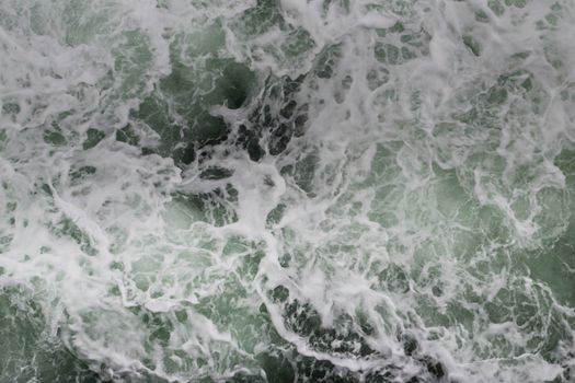 Big water splash seen from above a boat