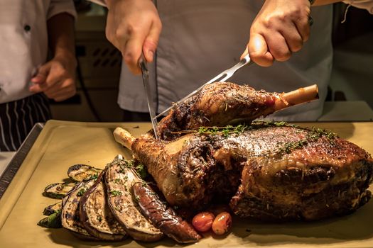 Carving of Roasted lamb meat