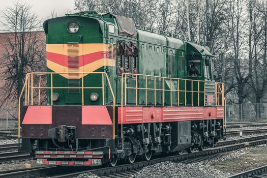 Green diesel cargo locomotive. Freight train in action