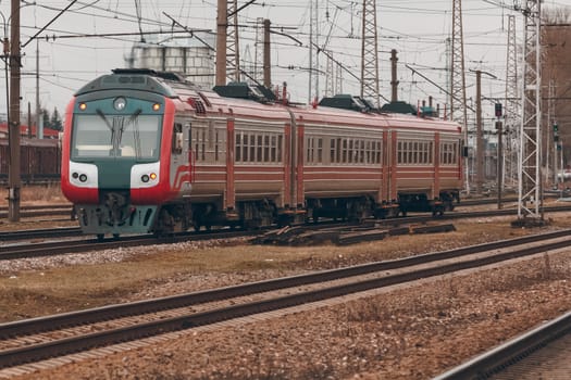 Red diesel passenger train driving at the old terminal