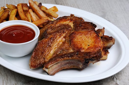 Fried pork loin steak with French fries and tomato sauce