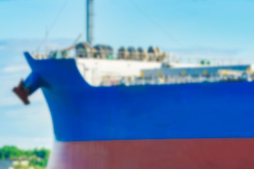 Blue cargo ship - soft lens bokeh image. Defocused background