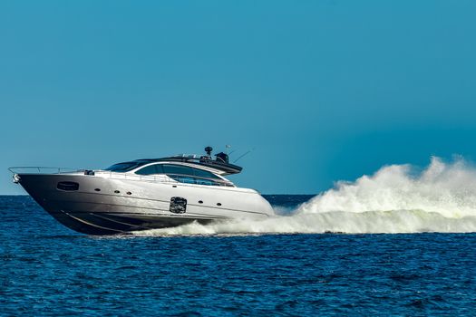 Grey speedboat moving fast by the river in Latvia. Water sport