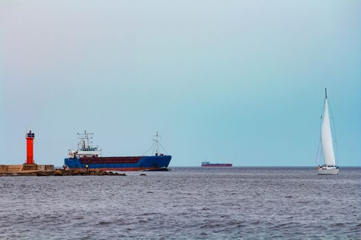 Merchandise import. Large blue cargo ship moving to Riga port