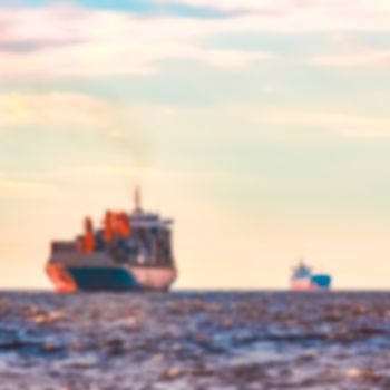 Blue cargo ship - soft lens bokeh image. Defocused background