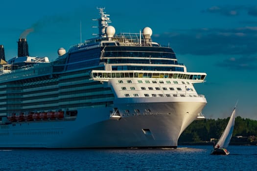 White giant brand new passenger ship moving in clear summer day