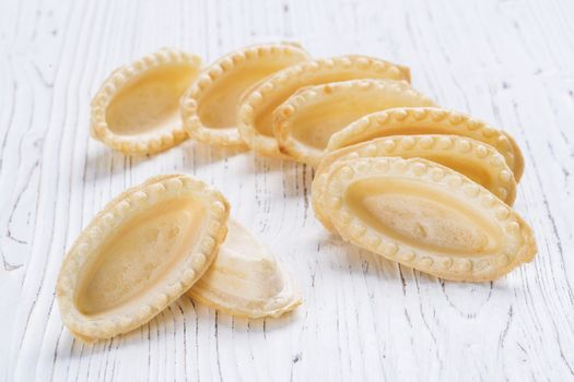 Empty tartlets on wooden background