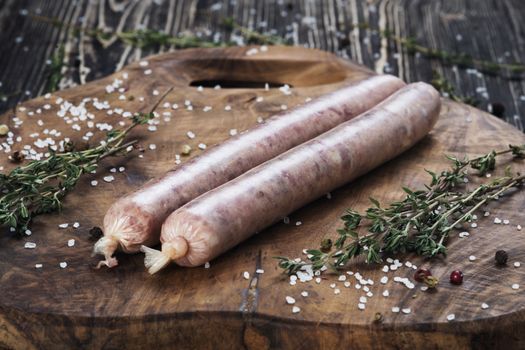 Raw sausages on the cutting board