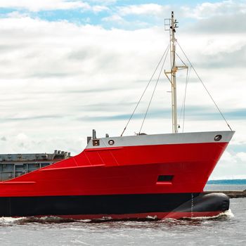 Red new cargo ship moving abroad. Product export in Europe