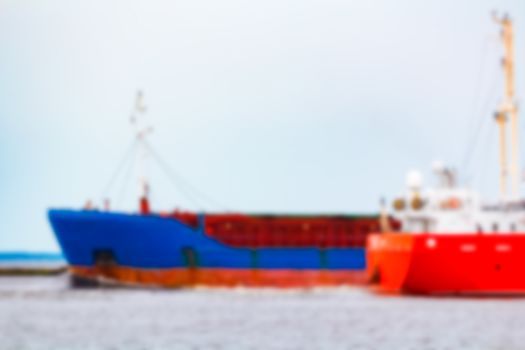 Blue cargo ship - soft lens bokeh image. Defocused background