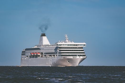 White cruise liner sailing on a clear day