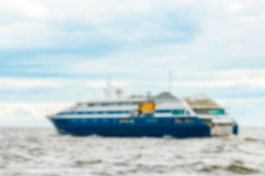 Blue passenger ship - soft lens bokeh image. Defocused background