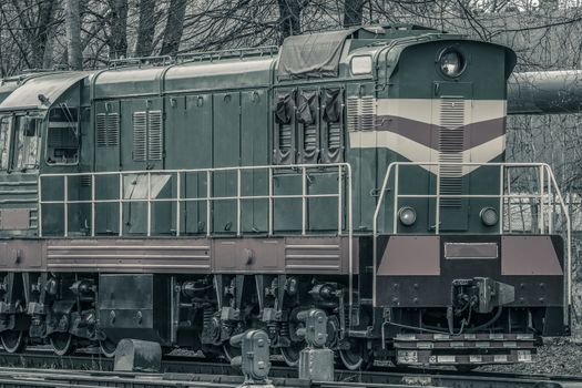 Old diesel cargo locomotive. Freight train in action